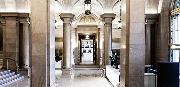 A restored historic interior of the library, showing gray columns and a shiny marble floor.